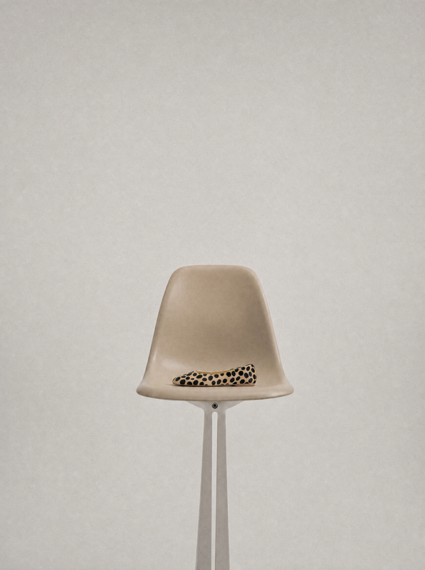 Shoe displayed on a sculptural chair